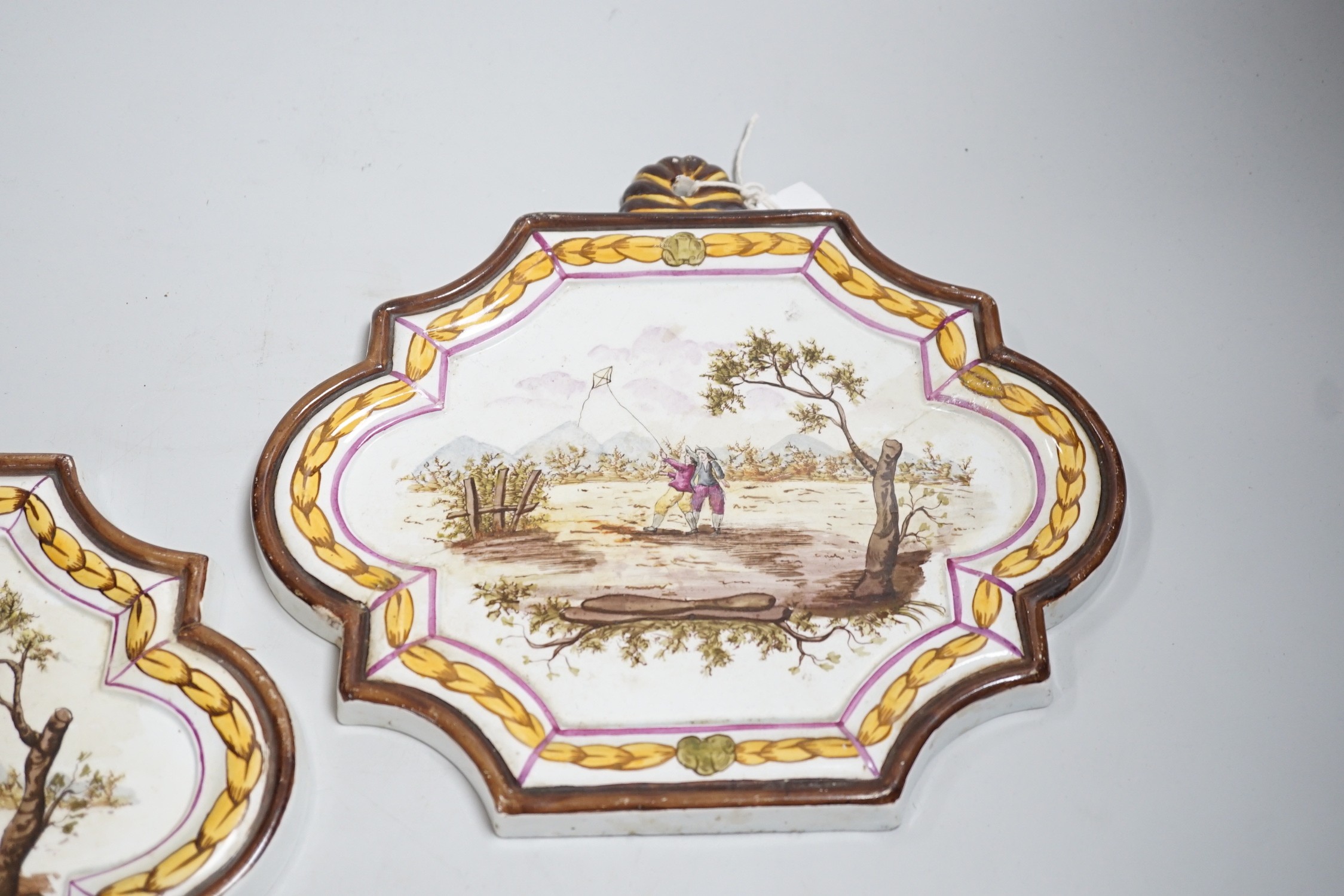 A pair of 19th century painted faience plaques in the style of Veuve Perrin 23cm